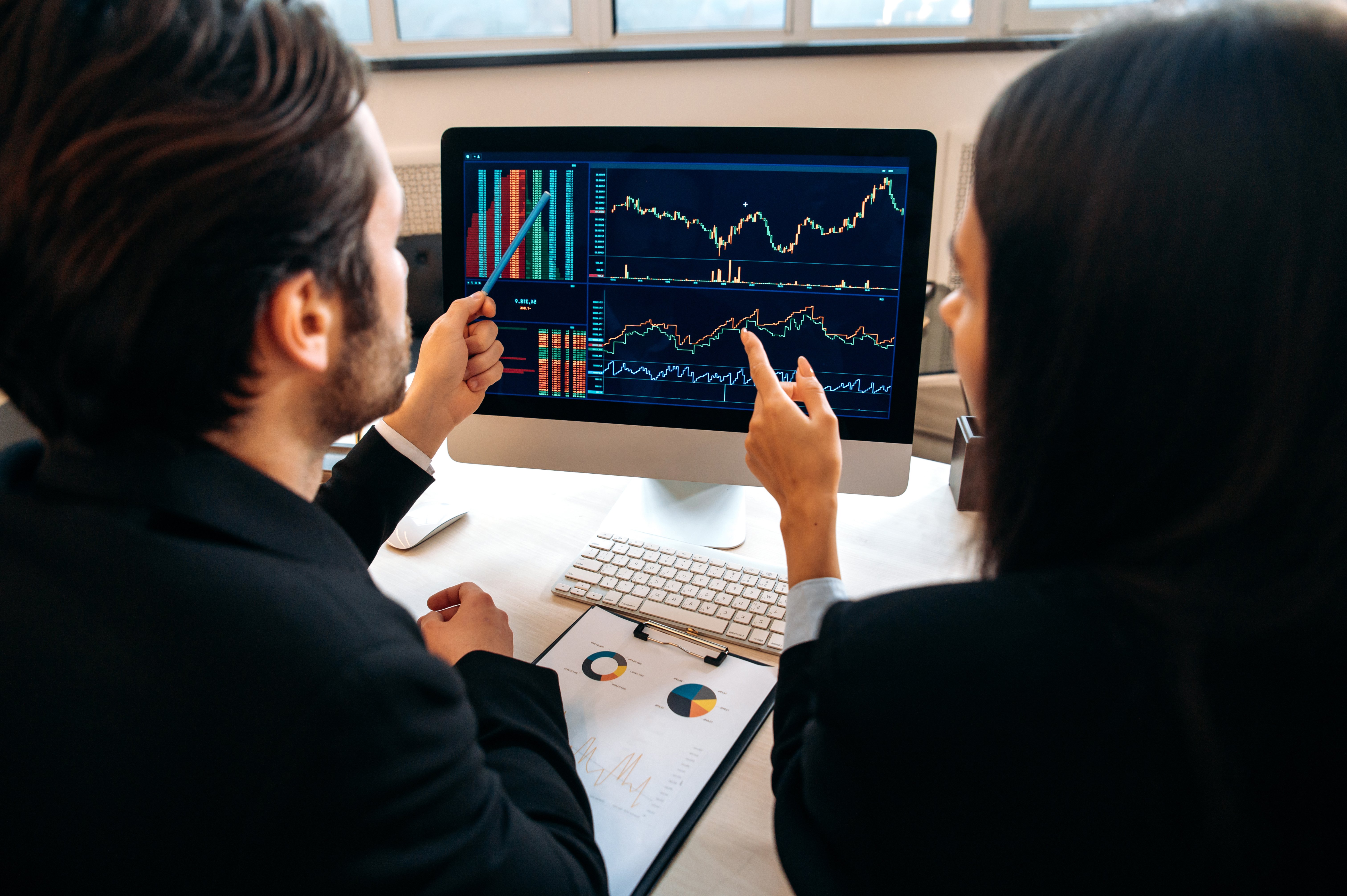 business-professionals-analyzing-stock-market-char-2026-01-08-22-22-35-utc