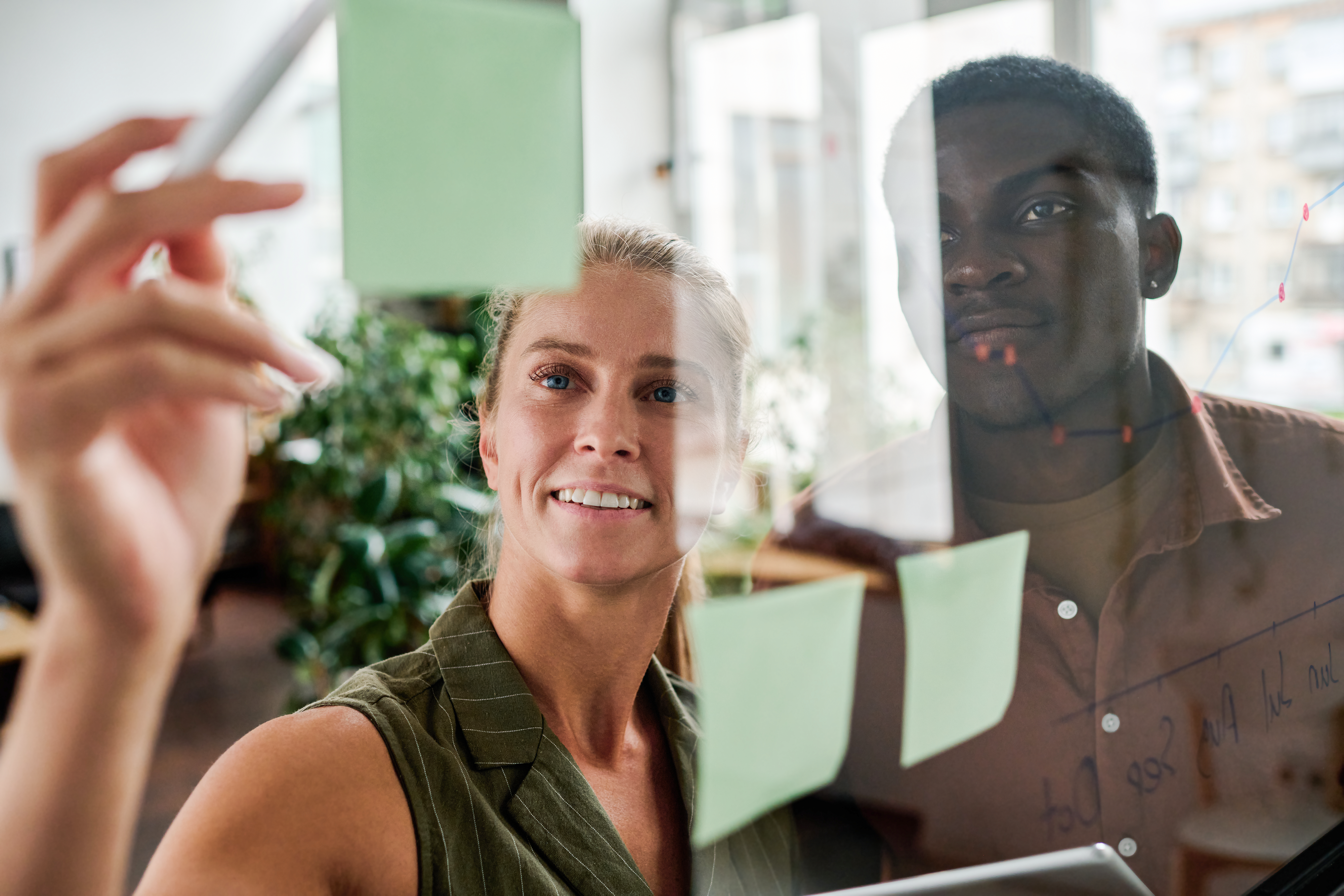 glassy_foreground_2_people_pointing_notes_office