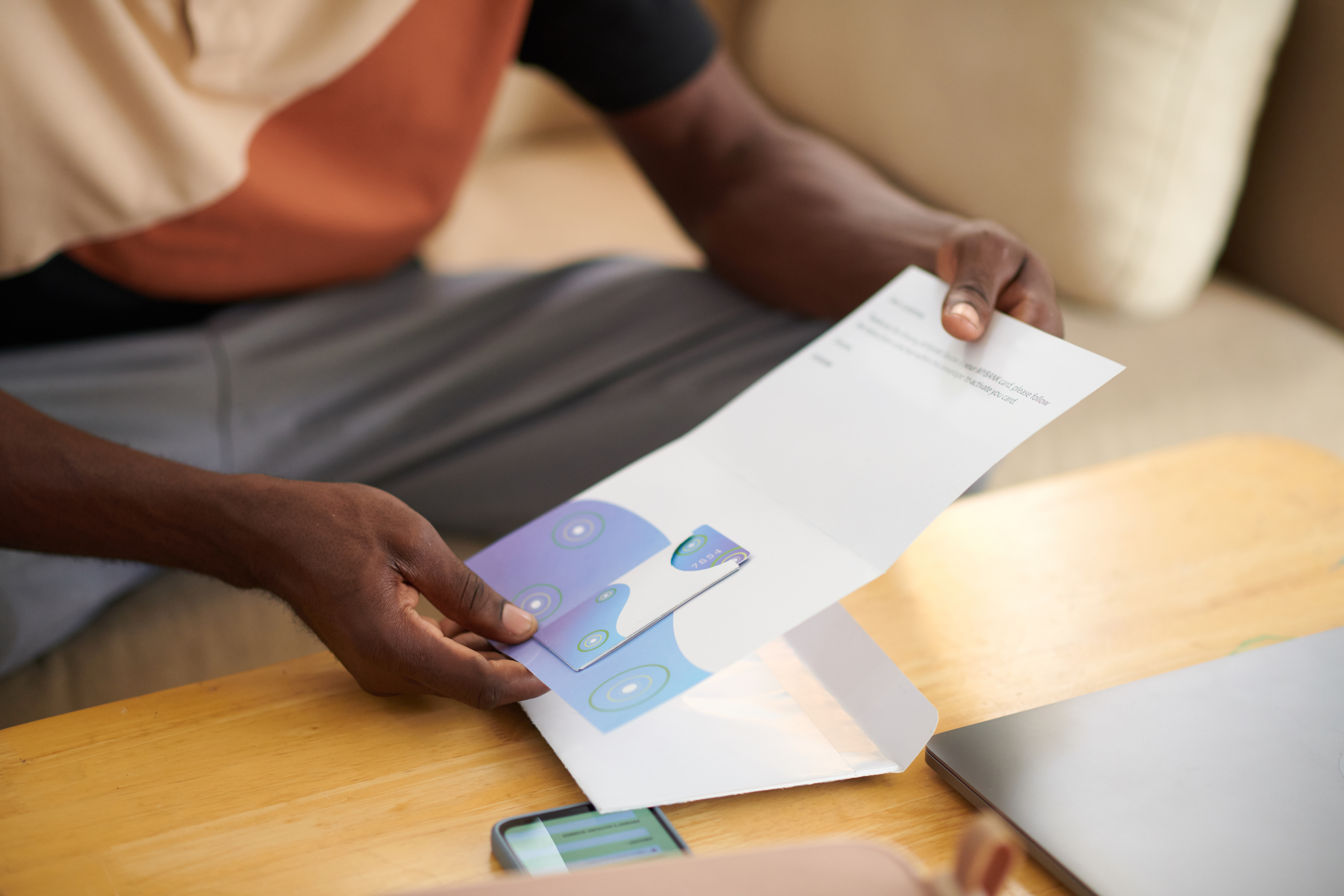 man-opening-bank-letter-with-credit-card-2026-01-07-07-05-10-utc